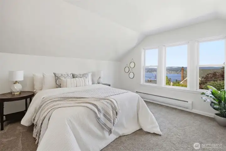 Experience the serenity of waking up to this Lakee Washington view every day. Located on the second floor, the primary bedroom offers a peaceful and tranquil retreat. This level  has big potential to be recreated into a primary suite in the future.