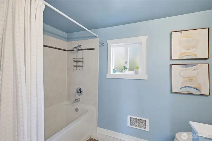 Updated full bathroom with deep soaking tub & tiled shower.