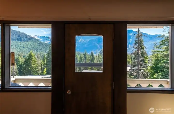 Wall of windows looking to private deck & mountain views. Wall of windows looking to private deck & mountain views.