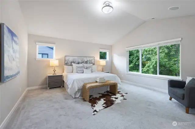 Huge primary bedroom with vaulted ceilings.