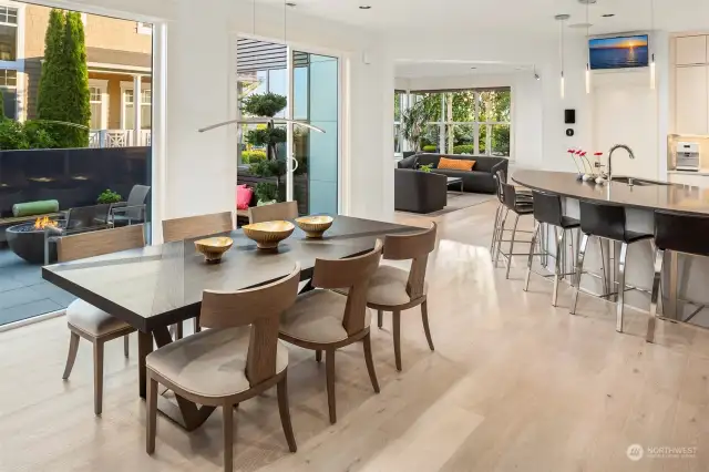 Spacious dining space with contemporary hanging light.  12' ceilings and surround sound system for setting the scene!