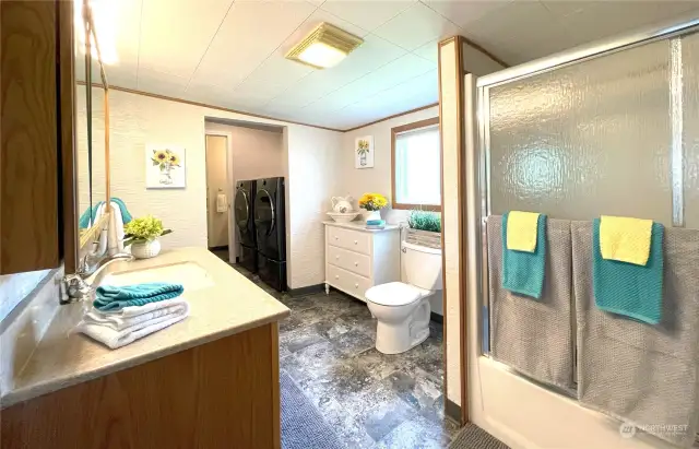 Large main floor guest bathroom is conveniently located between the main floor bedroom and living room.