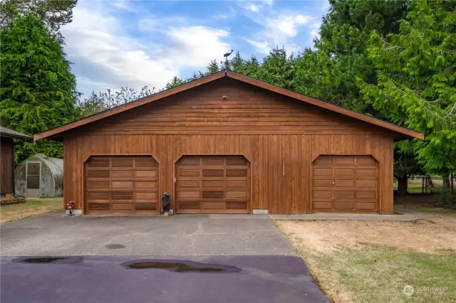 You can see the greenhouse in the back yard to the left of the garage and behind the house.