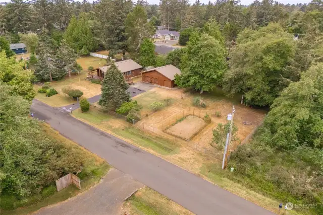 To the right of the garden is a double-wide drive-through gate.  It was formerly a long gravel driveway but grass has grown over it through the years.