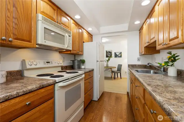 Look at this nicely updated kitchen with new counters lots of cabinets newer appliances recessed lighting and hard wood flooring just off your family room to cook all your meals in