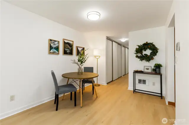 Here is view of large dining room area off the kitchen and great room big enough for 8 or more guests.  Check out the new hard surfaces,all new light bright white paint and updated lighting that comes with this beautiful 2bd 2 bath condo.  You can see the hallway with lots of extra storage also that comes with condo