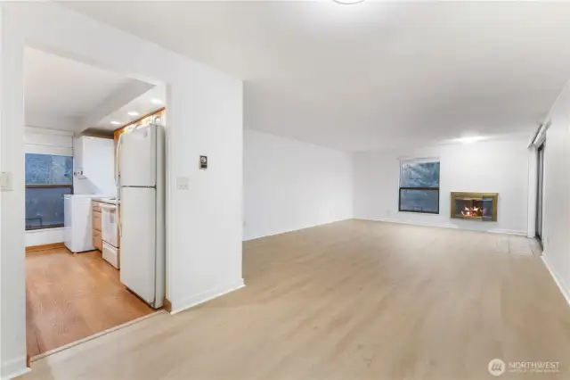 Here is second view of large family dining room with new hard flooring lighting paint and updated kitchen.  Stay warm and cozy by wood fireplace