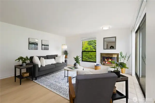 Second view of this nicely update condo with large family room and wood fireplace to relax by.  There is room for all your funiture also with views of nature out all your windows.  Come and see soon