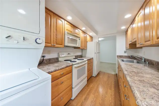 Second view of large updated kitchen with its own stack washer/dryer that stay with unit