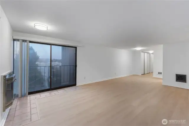 View from large family room looking back to enty kitchen area and looking to east outside with balcony for morning sun and cascade mountain views.  Check out new modern lighting all new interior paint and new hard surface flooring