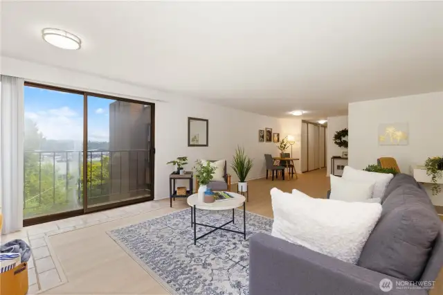 View of oversized staged great room with new lighting,new hard surface flooring,new painting and lots windows