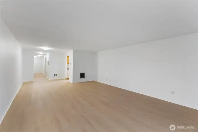 Family/great room view looking back to entry way with built in zonal heating new white floor to ceiling paint and lots of new hard surface flooring for easy care