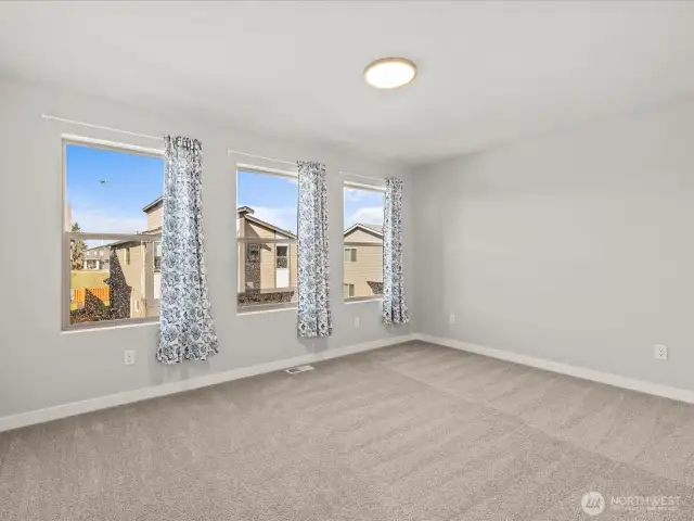 Secondary bedroom with wall of windows to fill this home with natural light.