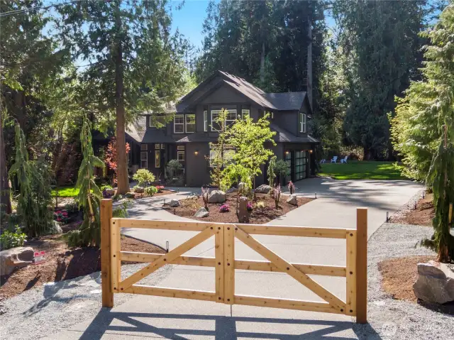 Freshly poured driveway, new gate & architectural landsacping