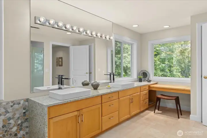 Double sinks, full height mirrors, a sit down vanity