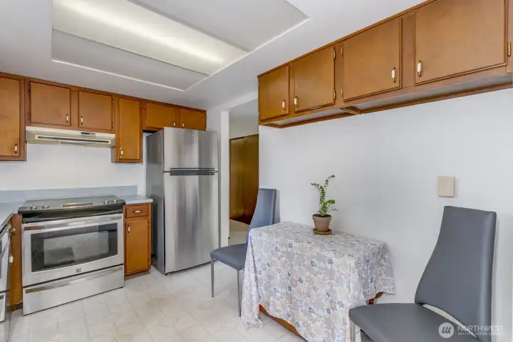The kitchen looks out over the back yard and opens to the dining area.