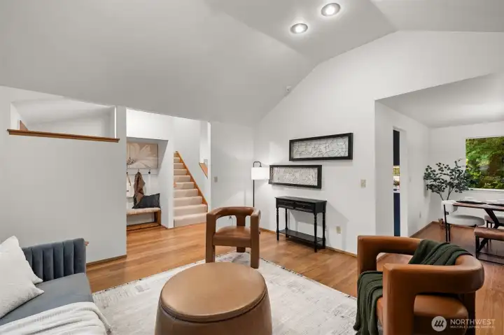 View from living room into hall with on-trend closet nook and stairs with brand new carpeting.