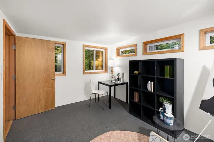 Basement storage room. Staged as an unheated hobby room. Not included in square footage.