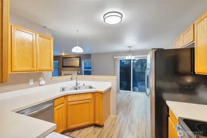 Easy flow between the kitchen and dining area with access to the backyard.