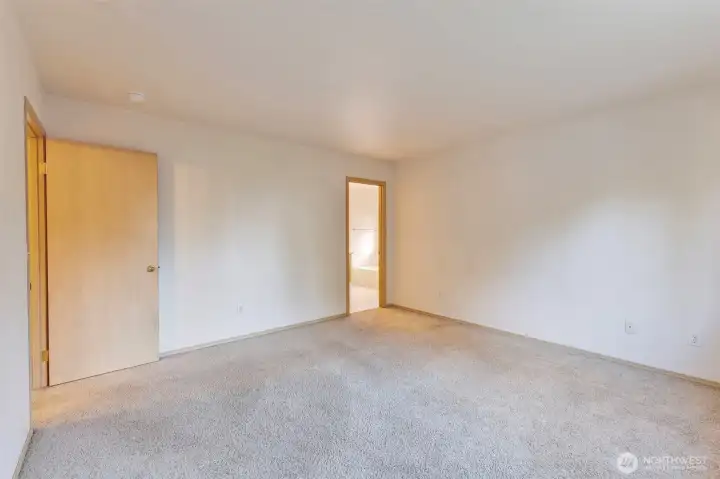 Another view of the primary bedroom with a private bath.
