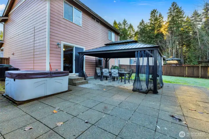 Hot tub for relaxation, gazebo for special gatherings in a fully fenced backyard adds privacy.