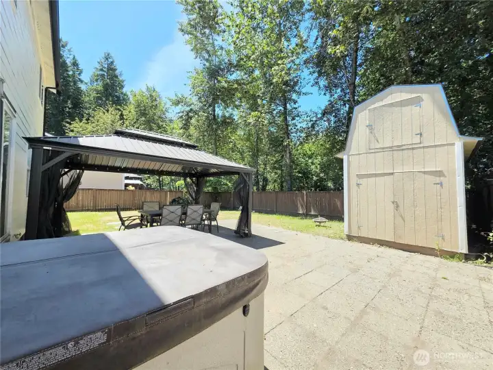 The backyard is perfect for entertaining with gazebo, hot tub, a versatile shed and spacious grassy area for play and a fenced yard.