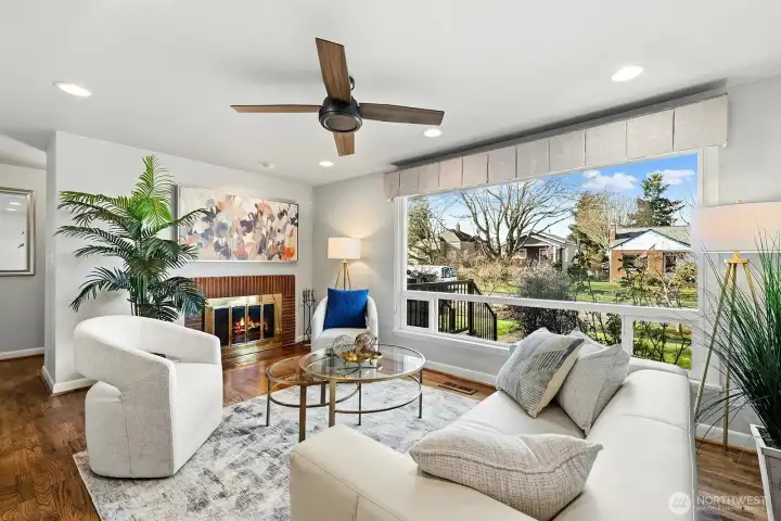 Enter to hardwood floors, huge double pane picture wiindow, ceiling fan and wood burning fireplace in the living room.