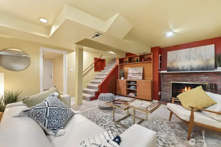 Lower level offers a cozy family room with second wood burning fireplace, built in for TV and storage and plenty of space for relaxation.