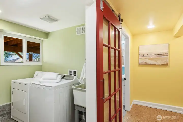 Sliding glass pane barn door keeps navigation easy in the lower hallway.