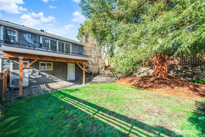 Looking at the house from the back one can see the scale of the patio. Also, note the heat pump/AC unit added in 2023.