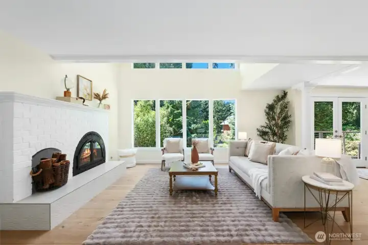 Light-filled living room with soaring double-height ceilings and walls of windows