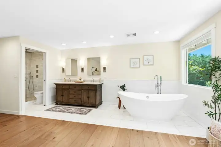 Ensuite bathroom featuring heated floors, designer tile, walk-in shower & standalone soaking tub