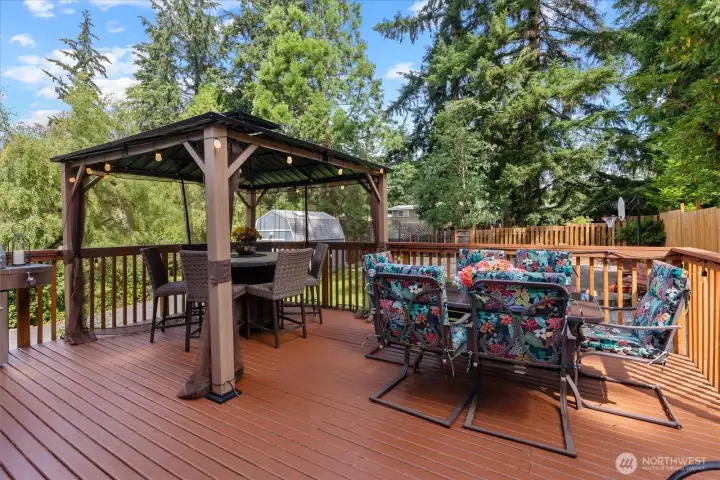 Relax on the deck looking over the peaceful backyard