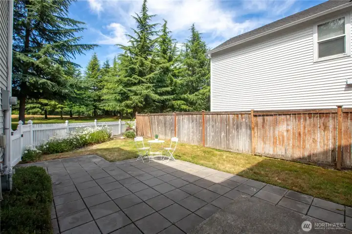 fenced backyard with paved patio