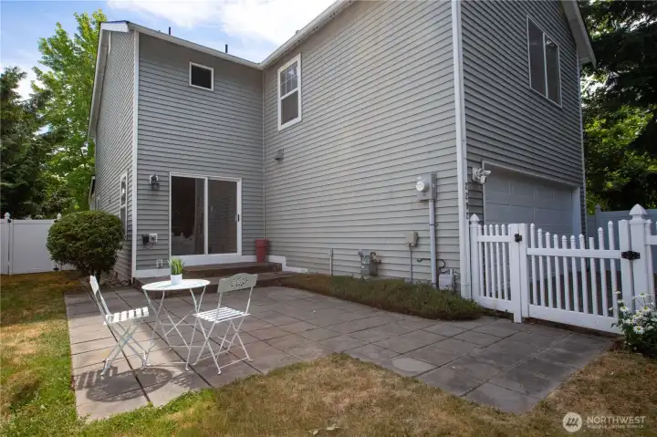 fenced backyard with paved patio
