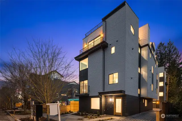 An evening masterpiece awaits you at The Veridian in Crown Hill. This stunning facade showcases modern architecture illuminated beautifully by twilight, hinting at the luxurious lifestyle.