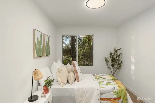 Bright and tranquil, this guest bedroom boasts serene views and thoughtful details to make everyone feel right at home—the perfect retreat for relaxation.