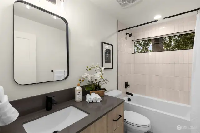 Experience modern luxury in this sleek bathroom featuring custom tile work, stylish fixtures, and a spa-inspired ambiance. It is the ideal place to recharge after a long day.