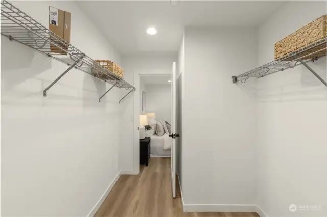 This spacious walk-in closet ensures all your belongings have a place, with plenty of shelving and storage to keep your wardrobe organized and accessible.