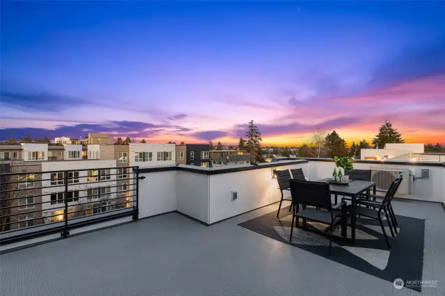 Unwind or entertain on the expansive rooftop deck, where panoramic sunset views set the stage for memorable evenings. This outdoor oasis truly elevates urban living.