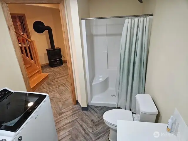 Utility/bathroom with walk in shower.