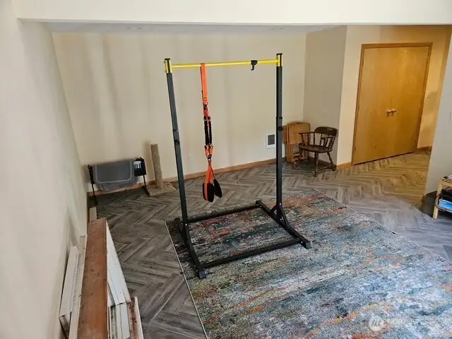 Huge recreation room that could be converted to a combined kitchen and living area that's just down the hall from the bathroom/utility room and the bedroom.