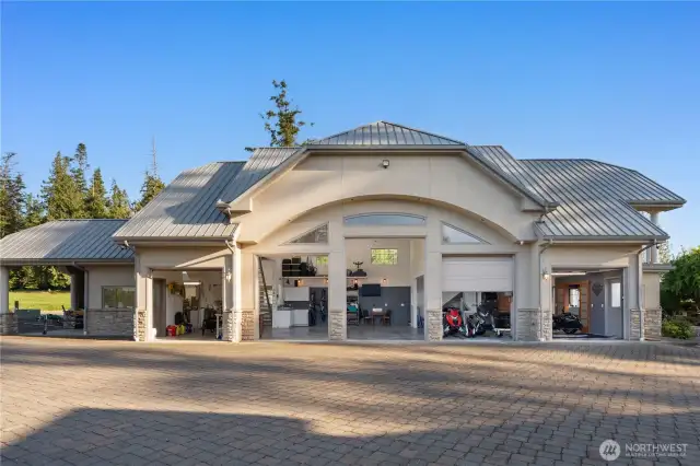 Stunning car lovers garage with six bays, a Gardners Den, private guest suite and two bathrooms