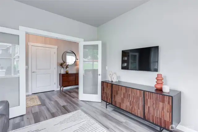 French doors lead from the den to the front hall