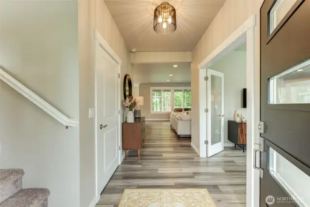 View from the entrance. Straight ahead is the kitchen, dining and great room. To the right is a room which can be used for a den or office.