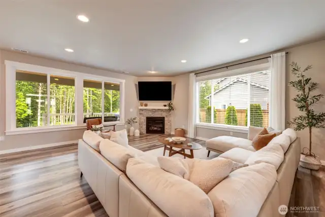 The great room looks out onto the sprawling, tree-lined back yard.