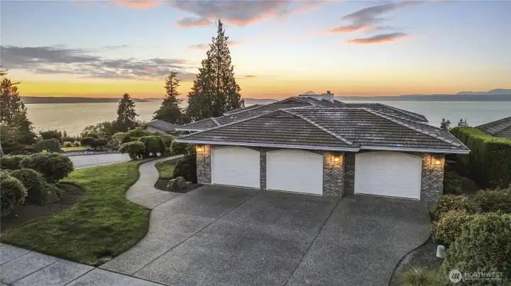 Three-car attached garage on the back side.