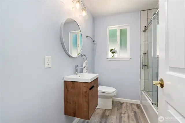 Hallway bathroom with a tub