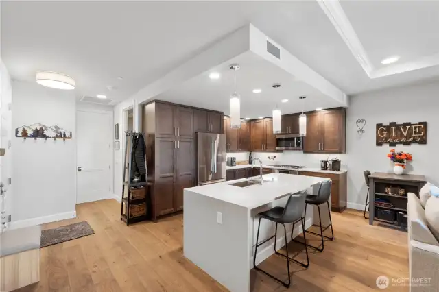 Style meets hidden function.  This kitchen doesn't just look beautiful—it works hard for you. With a hidden junk drawer cleverly tucked into the cabinetry and soft-close drawers throughout, it's designed for those who value clean lines and smart storage. Plus, all the high-end stainless steel appliances stay with the unit, making move-in that much easier.