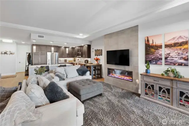 Designed for togetherness.  This warm, open space invites both conversation and comfort. Plush seating wraps around a cozy electric fireplace, while the oversized kitchen island keeps the cook connected to the rest of the room. Whether you're entertaining guests or enjoying a quiet evening, the design makes you feel at home and in control.
